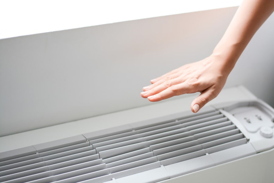 hand-over-AC-unit